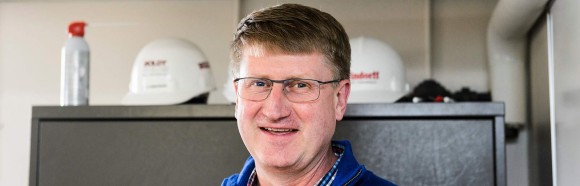 Mike Kinderman, director of University Housing Residence Halls Facilities, stands in his office at Turner House at the University of Wisconsin-Madison on March 20, 2018 with a collection of construction-hard hats from previous renovation projects. Kinderman is one of nine recipients of a 2018 Academic Staff Excellence Award (ASEA).