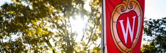 A W crest banner flutters in the wind on Bascom Hill at the University of Wisconsin-Madison during autumn on Oct. 18, 2019.