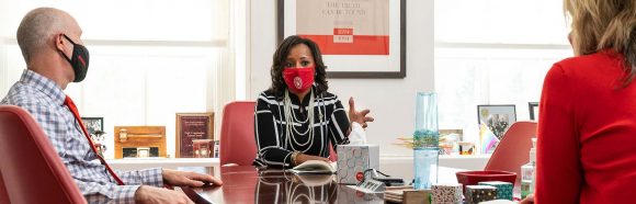 Wearing a face mask and physical distancing during the global coronavirus (COVID-19) pandemic, Cheryl Gittens, interim deputy vice chancellor for diversity and inclusion and chief diversity officer at the University of Wisconsin-Madison, is pictured talking with Lori Reesor, vice chancellor for student affairs, and Argyle Wade, chief of staff, in Reesor’s office in Bascom Hall on September 23, 2020.