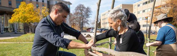 School of Human Ecology professors, Brian McInnes and Marianne Fairbanks help with the construction of the Ciiporoke. Members of the Ho Chunk Nation, volunteers, and campus community members experience the building of a Ciiporoke, a Ho-Chunk dwelling, as well as participate in making traditional foods and baskets on the North Lawn of Dejope at the University of Wisconsin–Madison on Nov. 3, 2022.