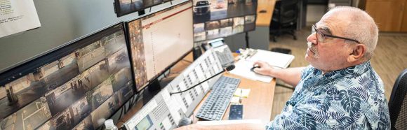 Greg Gorman, dispatcher with Transportation Services at the University of Wisconsin-Madison, monitors a bank of video displays showing parking exits across the campus lots from his office located in Lot 75 on June 23, 2022. Gorman is a recipient of a 2022 University Staff Recognition Award.