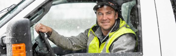 Anton Slobounov, grounds crew member at the University of Wisconsin-Madison, is pictured with a pickup truck fitted with a snow plow used to clear sidewalks and parking lots during a snow storm on Feb. 16, 2023.