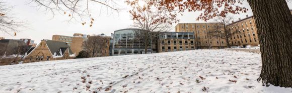 The Law Building is framed by snow and fall leaves on a winter day at the University of Wisconsin–Madison on Dec. 11, 2025.